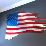 american flag cut out of aluminum hanging on a wall